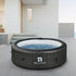Relxtime round black inflatable hot tub in the backyard
