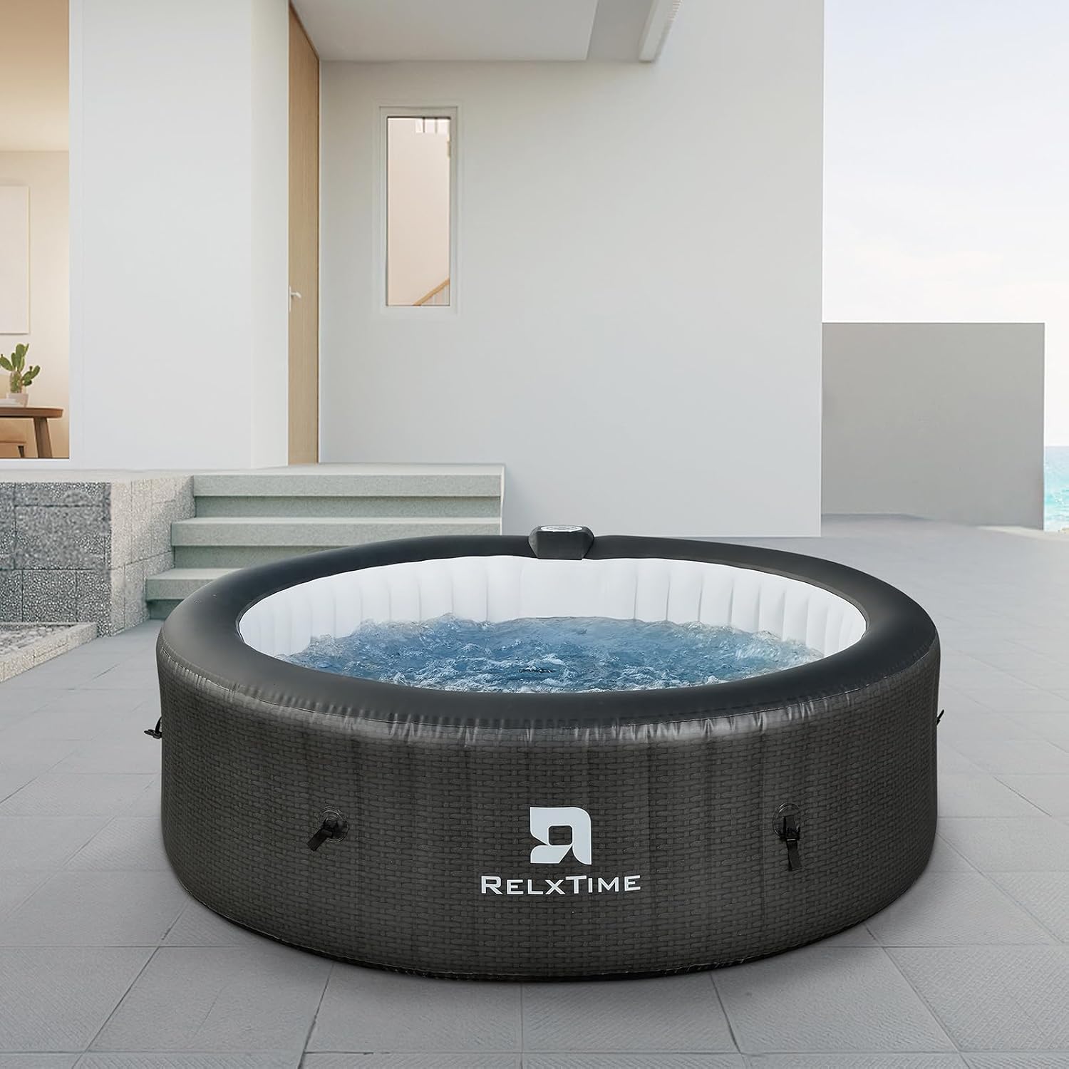 Relxtime round black inflatable hot tub in the backyard

